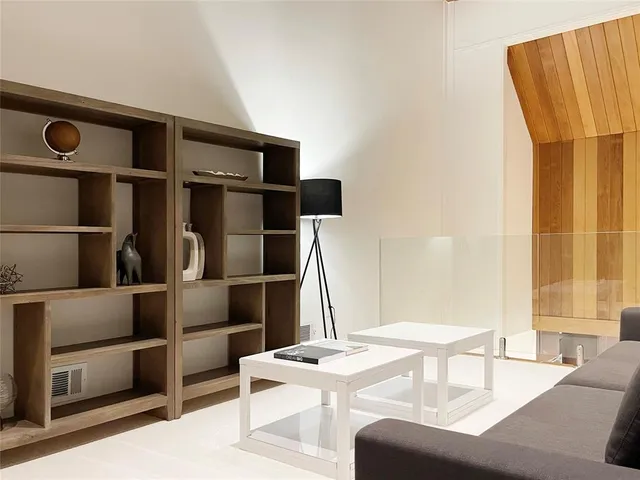 a view of a living room with furniture and a flat screen tv