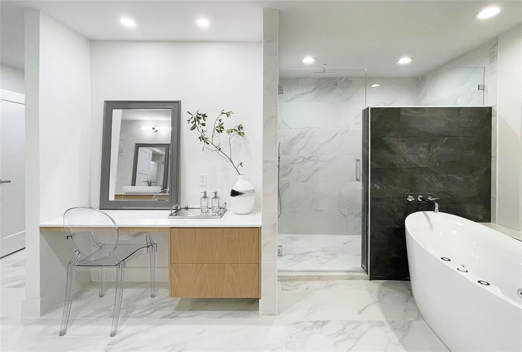 6802 Bert Lane Dallas, TX 75240 - Photo 33 of 38 a bathroom with a bathtub a toilet a sink and mirror