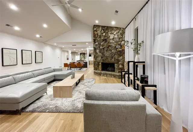 a living room with furniture and a fireplace