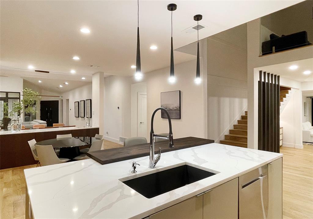 6802 Bert Lane Dallas, TX 75240 - Photo 6 of 38 a kitchen with a sink a counter space appliances and cabinets