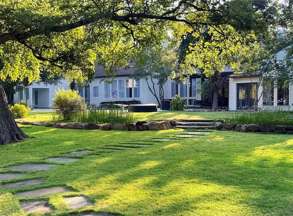 a house view with a sitting space and garden