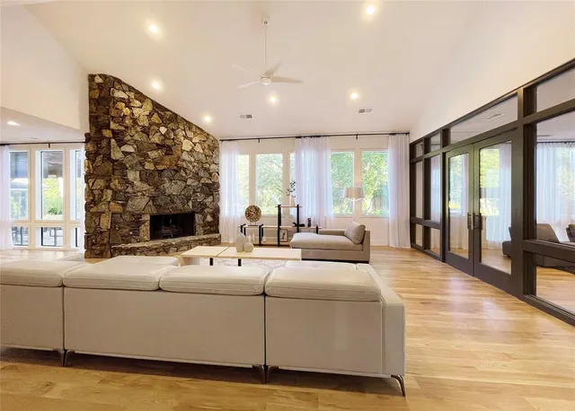 a living room with furniture and large windows