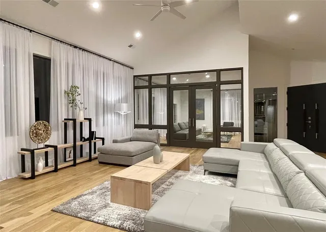 a living room with furniture and large windows