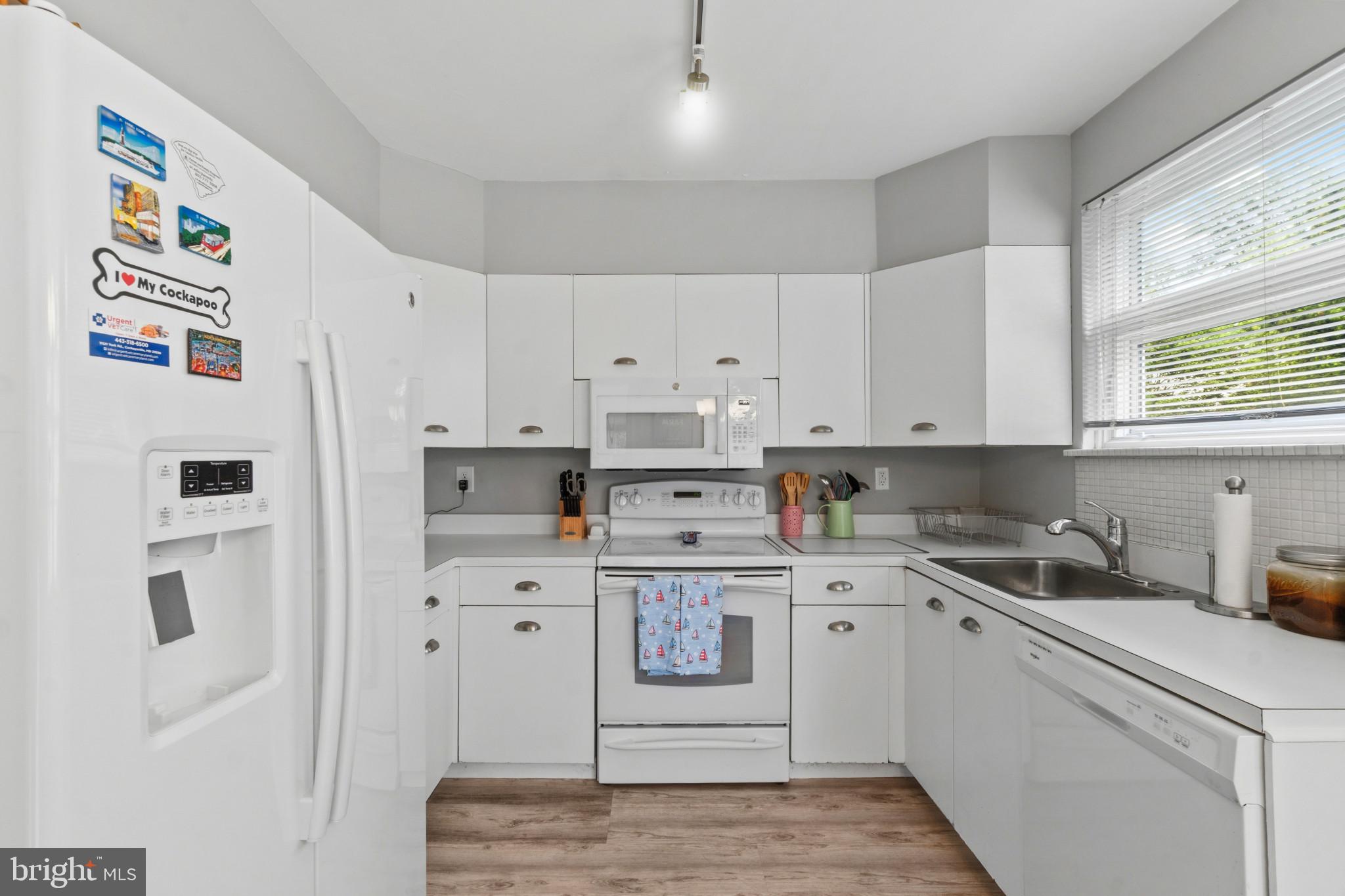 909 Weatherbee Road Towson, MD 21286 - Photo 15 of 51 a kitchen with white cabinets and white appliances