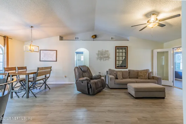 a living room with furniture and a wooden floor