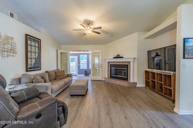 a living room with furniture and a fireplace