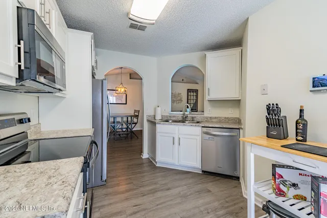 a kitchen with stainless steel appliances granite countertop a stove and a sink