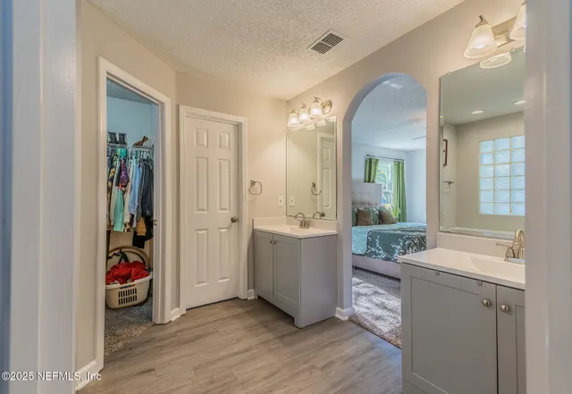 a view of a hallway and dining room with wooden floor
