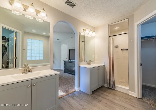 a bathroom with a double vanity sink mirror and double