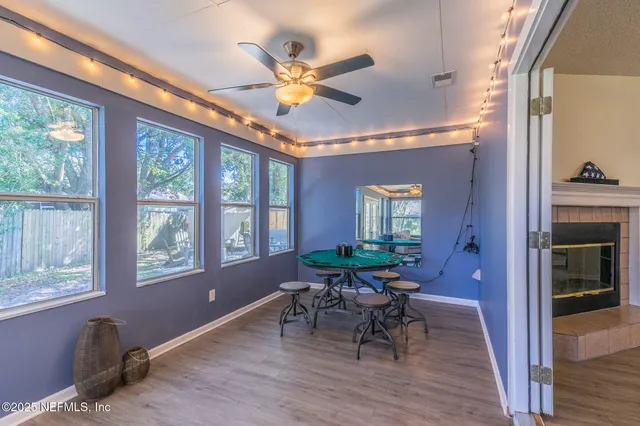 a workspace with wooden floor and windows