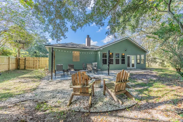 a view of a house with backyard porch and sitting area