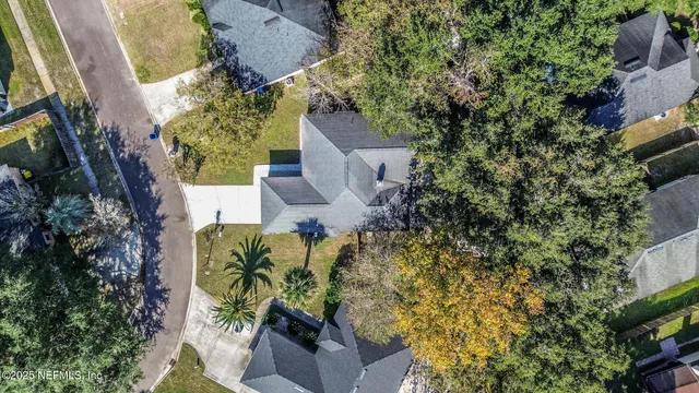 an aerial view of a house with a yard and sitting area
