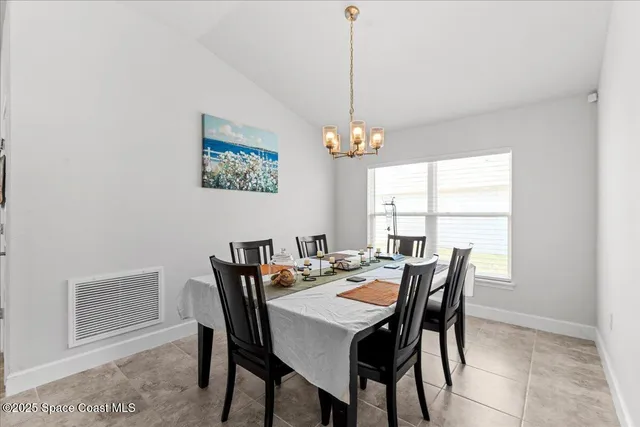 a view of a dining room with furniture window and outside view