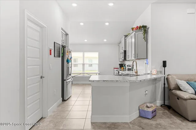 a kitchen with a sink and a refrigerator
