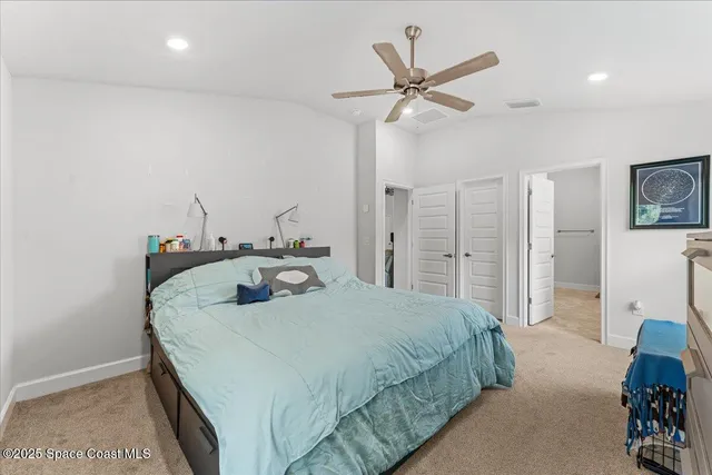 a bathroom with a granite countertop sink a toilet and a mirror