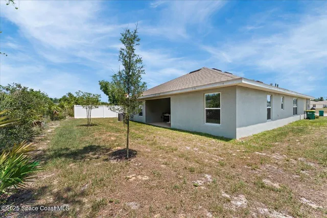 a view of a yard with trees in the background
