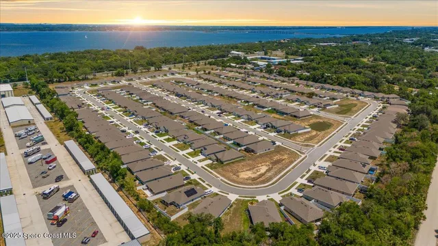 an aerial view of a house with swimming pool and outdoor seating