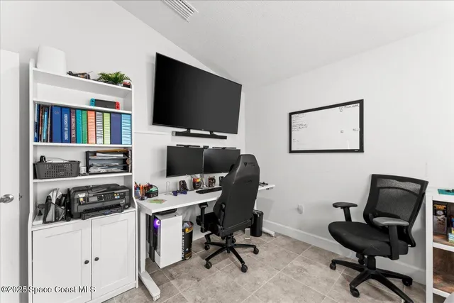 a view of a workspace with furniture