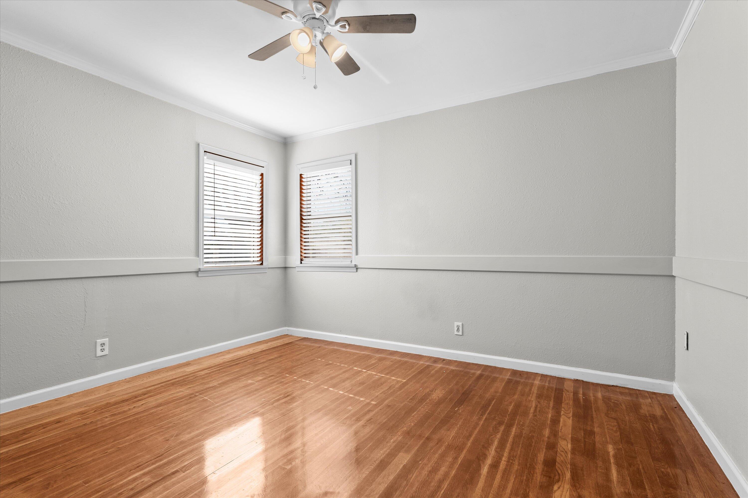 2009 65th Street Lubbock, TX 79412 - Photo 13 of 24 an empty room with wooden floor and windows