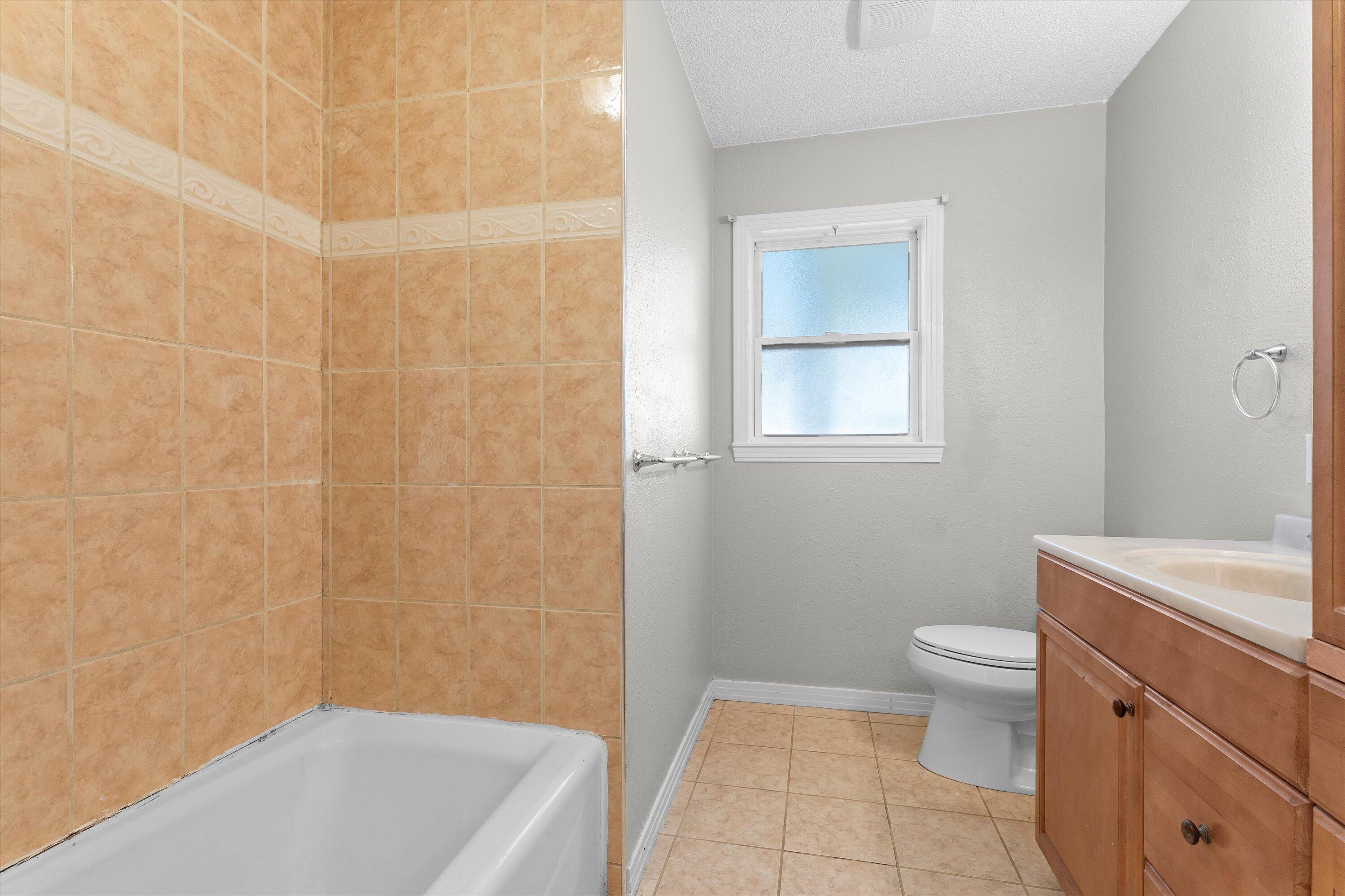 2009 65th Street Lubbock, TX 79412 - Photo 17 of 24 a bathroom with a sink a toilet and shower