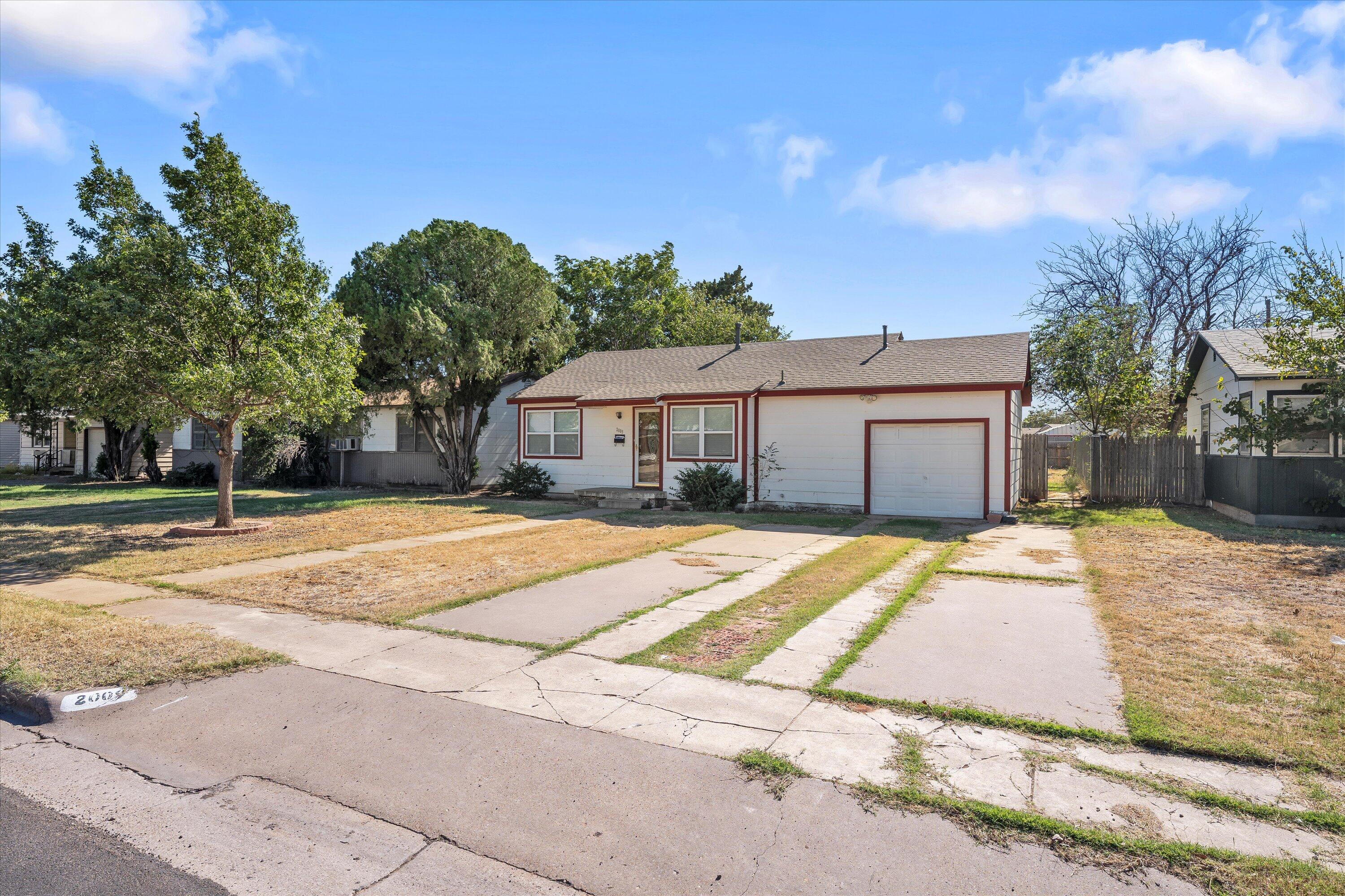 2009 65th Street Lubbock, TX 79412 - Photo 2 of 24 a front view of a house with a garden
