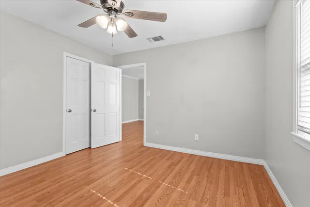 wooden floor in an empty room with a window