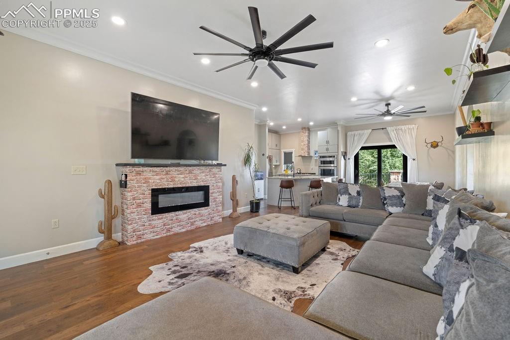 8450 Edison Road Yoder, CO 80864 - Photo 5 of 50 a living room with furniture a fireplace and a flat screen tv