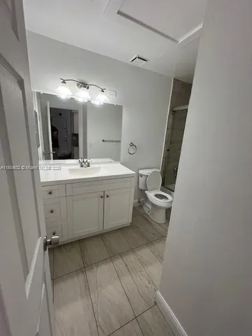a bathroom with a sink a toilet and mirror