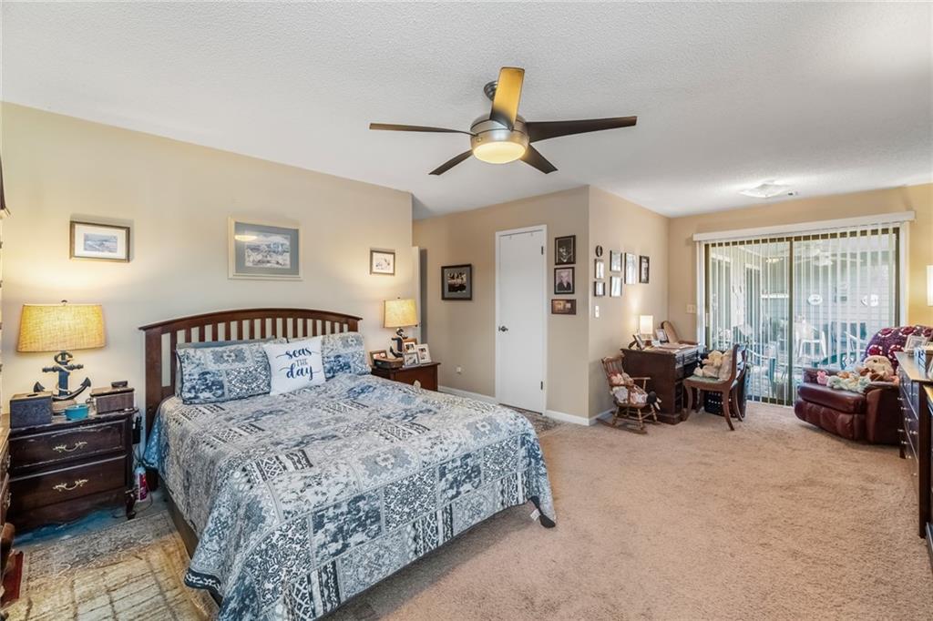 3492 Rosebud Road Loganville, GA 30052 - Photo 12 of 22 a bedroom with a large bed and a couch