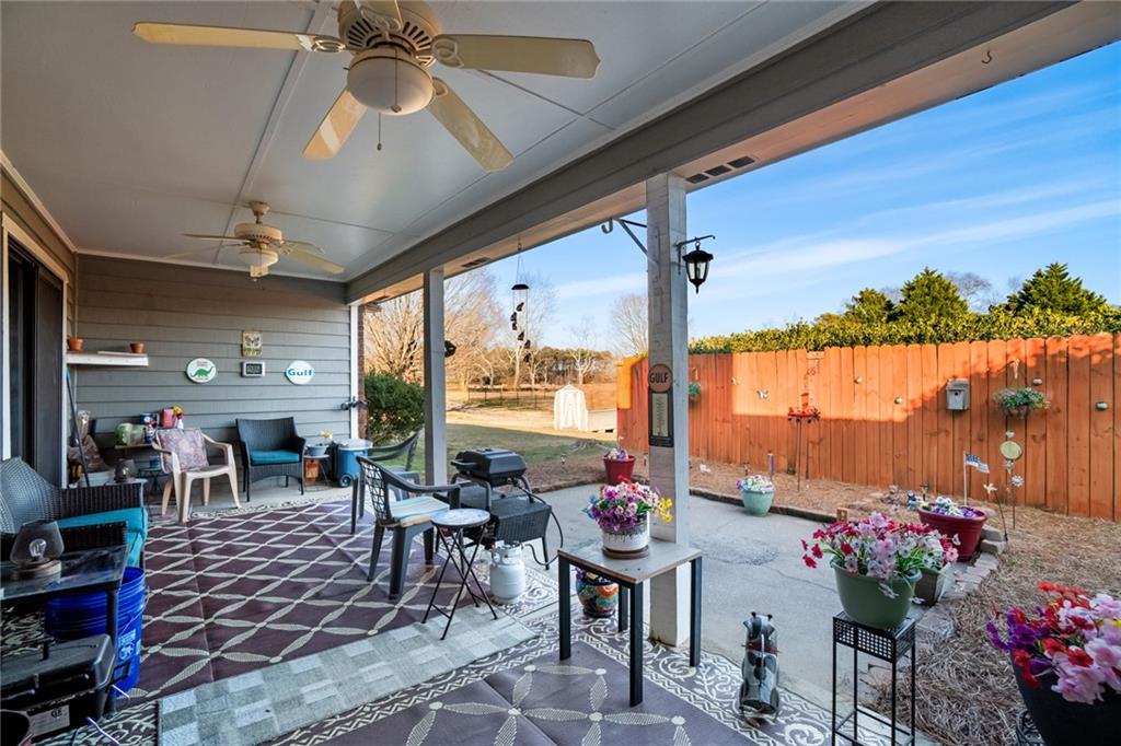 3492 Rosebud Road Loganville, GA 30052 - Photo 18 of 22 a outdoor dining space with furniture and garden view