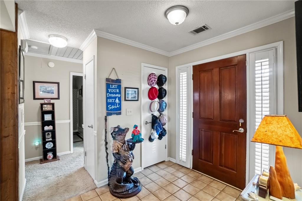3492 Rosebud Road Loganville, GA 30052 - Photo 3 of 22 a living room with furniture and a chandelier