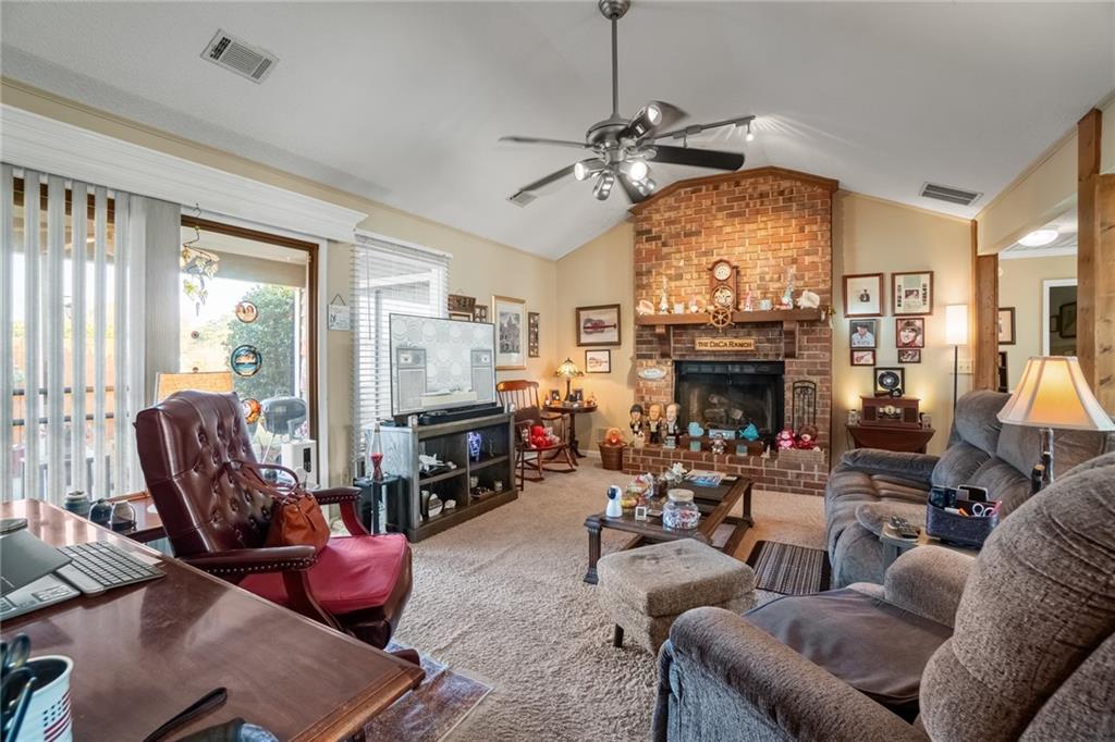 3492 Rosebud Road Loganville, GA 30052 - Photo 5 of 22 a living room with furniture a fireplace and a large window