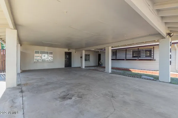 a view of an empty room with a fireplace and a window