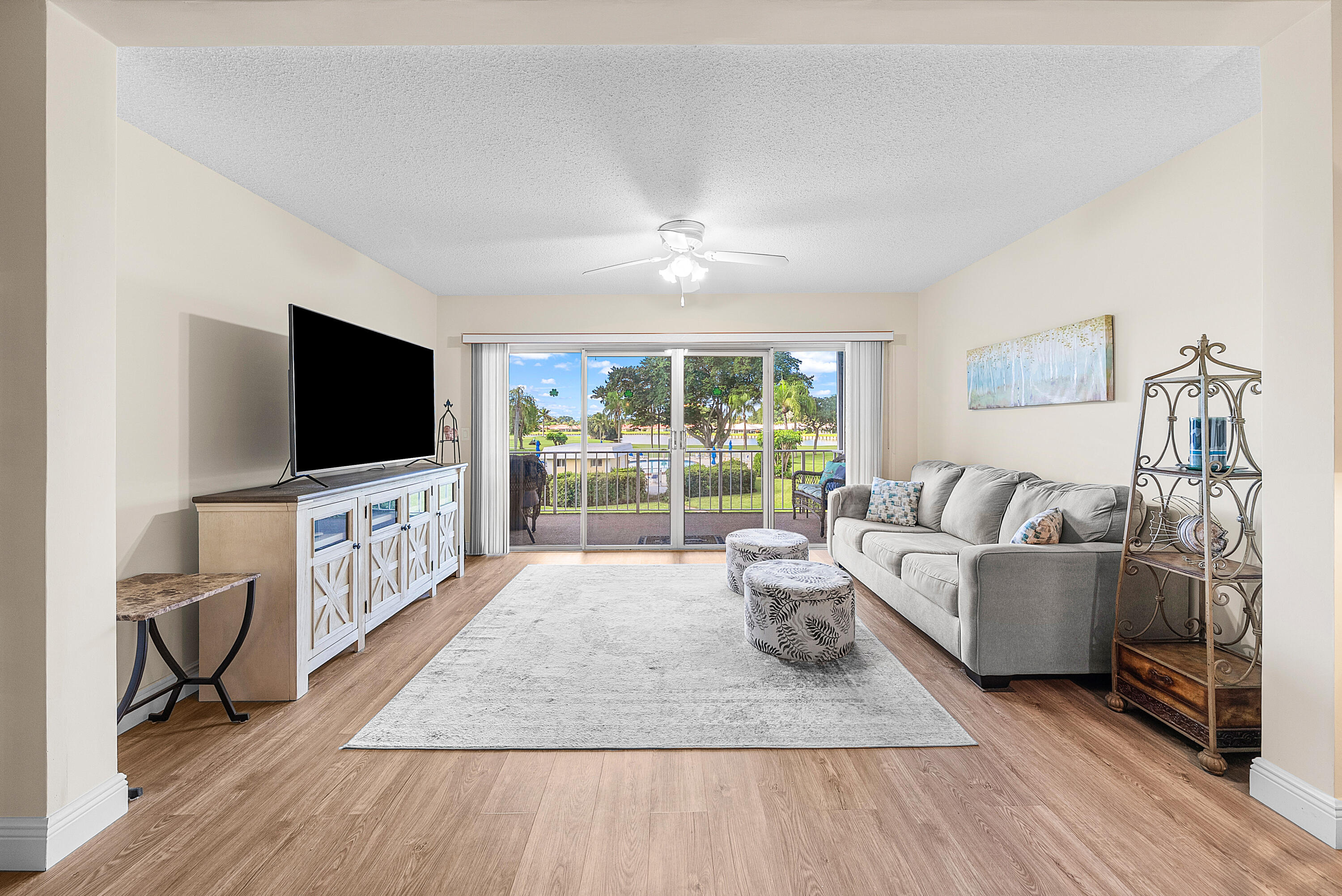 145 Atlantis Boulevard, Unit 203 Atlantis, FL 33462 - Photo 11 of 33 a living room with furniture and a flat screen tv