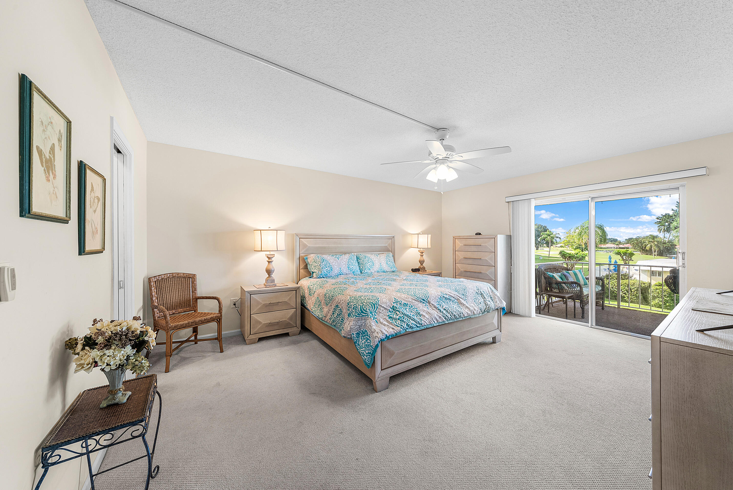 145 Atlantis Boulevard, Unit 203 Atlantis, FL 33462 - Photo 12 of 33 a bedroom with a bed mirror and window