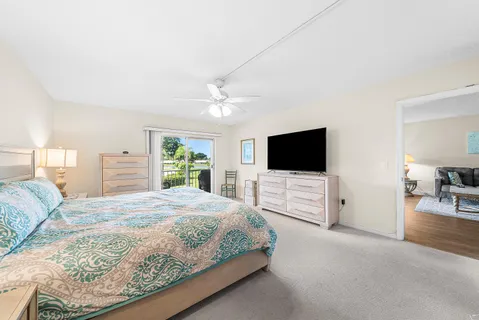 a bedroom with a large bed and a flat screen tv