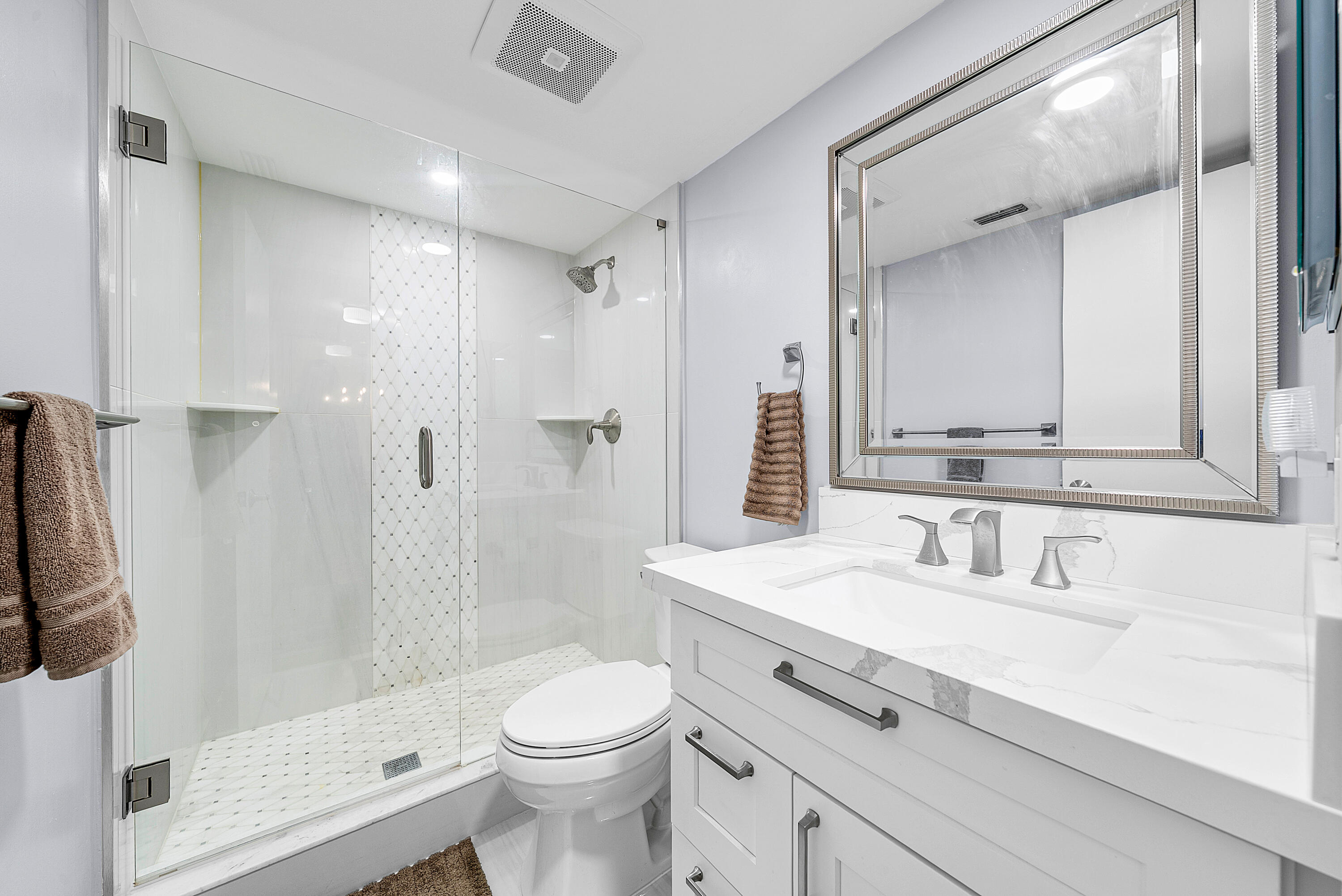 145 Atlantis Boulevard, Unit 203 Atlantis, FL 33462 - Photo 19 of 33 a bathroom with a sink a toilet and shower