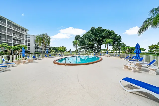 a swimming pool with outdoor seating and yard