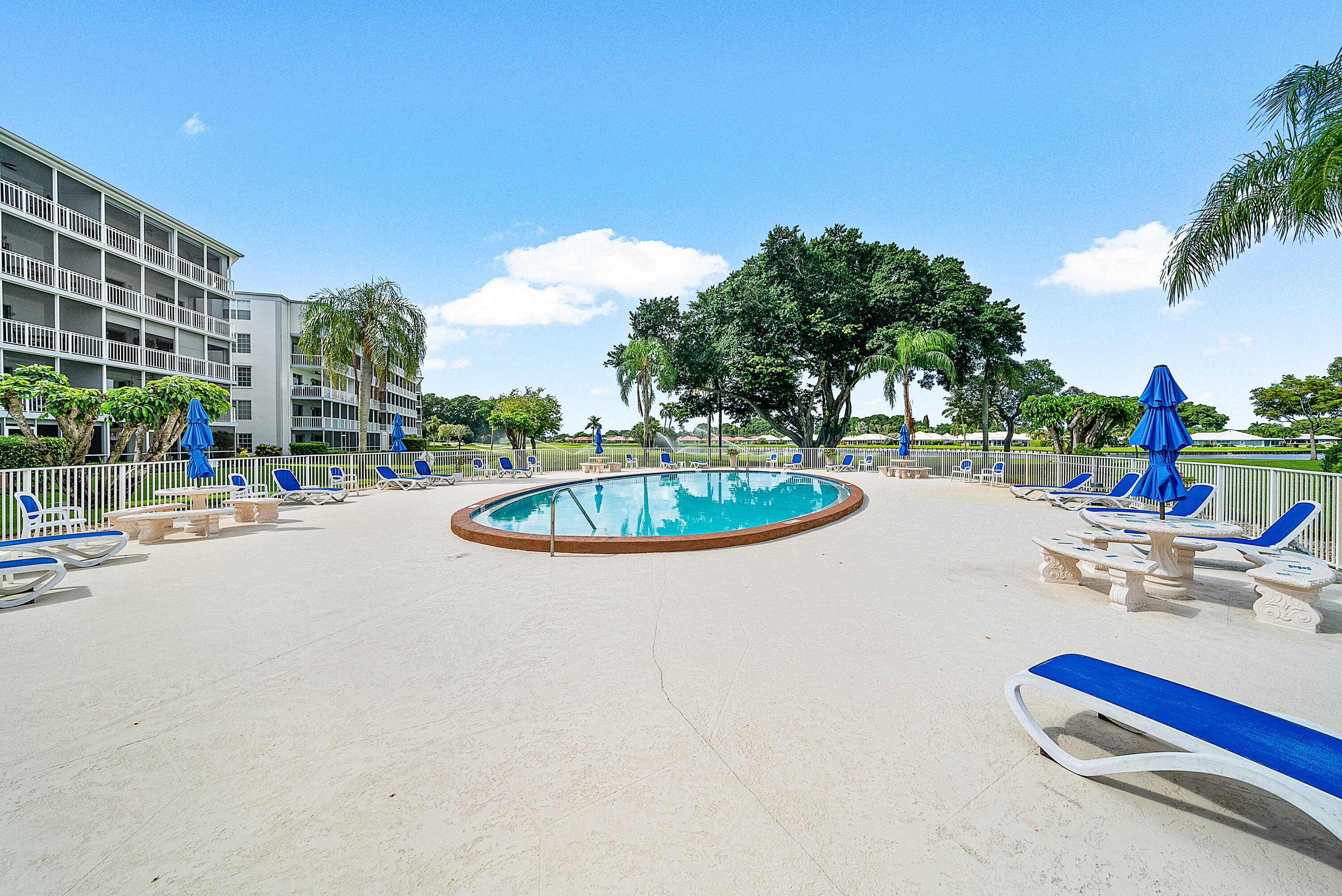 145 Atlantis Boulevard, Unit 203 Atlantis, FL 33462 - Photo 24 of 33 a swimming pool with outdoor seating and yard