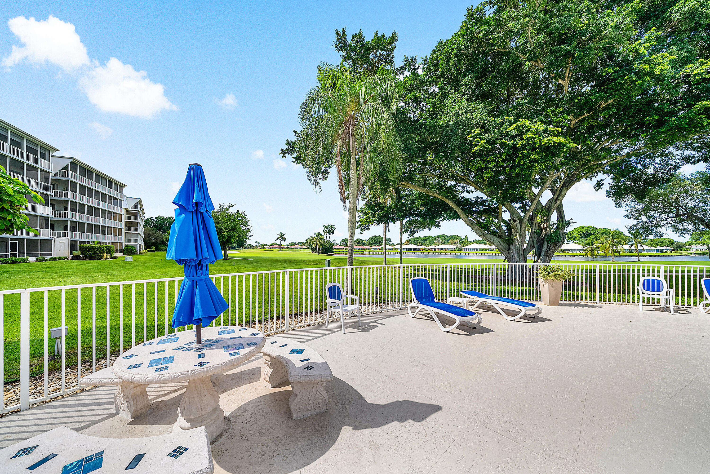 145 Atlantis Boulevard, Unit 203 Atlantis, FL 33462 - Photo 25 of 33 a park view with a bench and garden