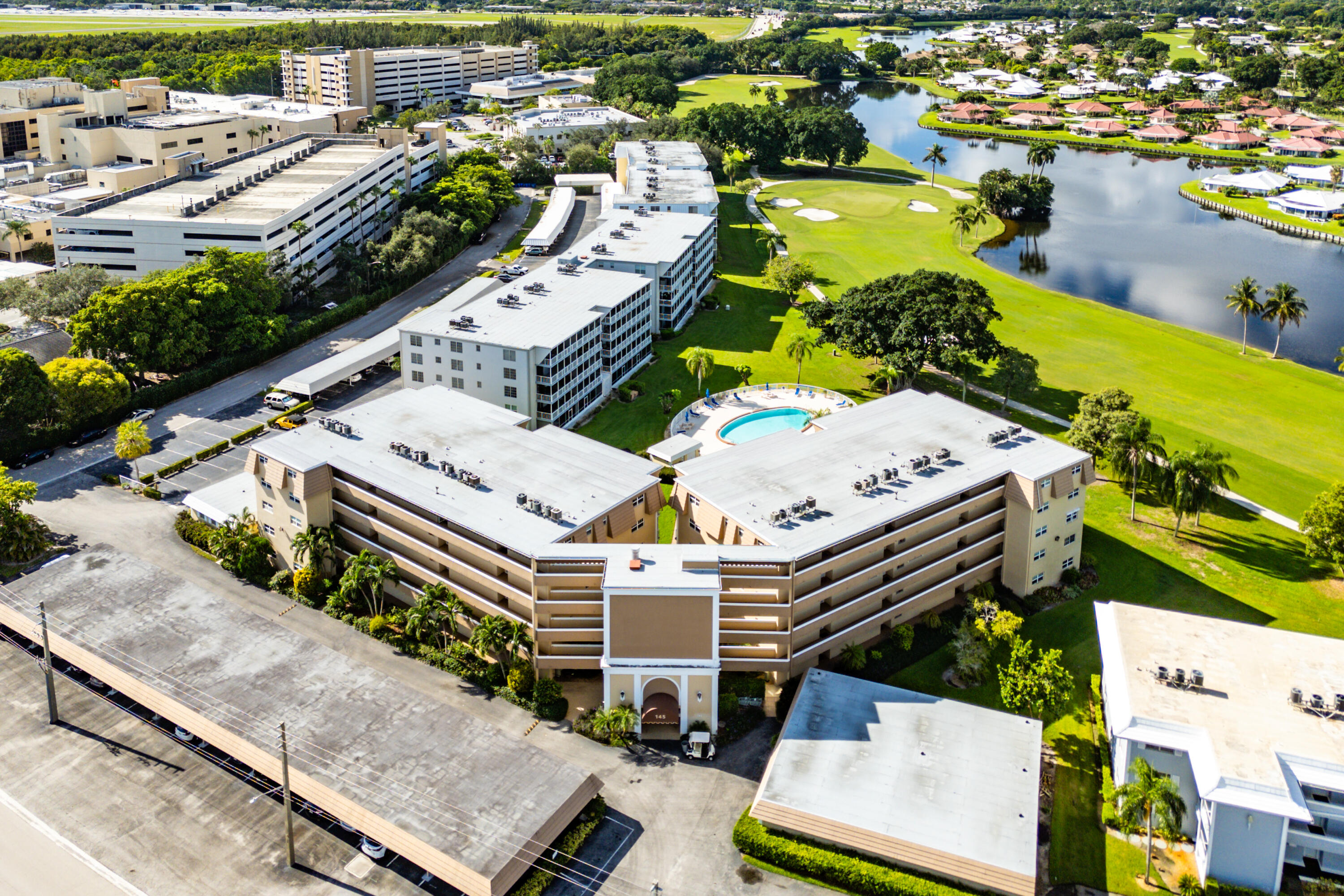 145 Atlantis Boulevard, Unit 203 Atlantis, FL 33462 - Photo 32 of 33 an aerial view of a house with a swimming pool yard and outdoor seating