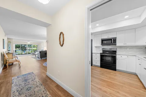 a kitchen with a refrigerator and a stove top oven