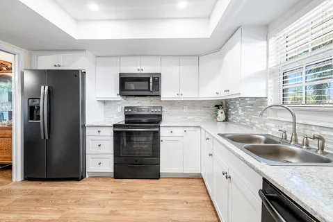 a kitchen with a sink stove and refrigerator