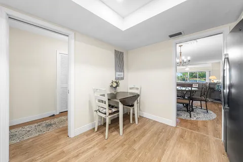 a dining room with furniture and wooden floor