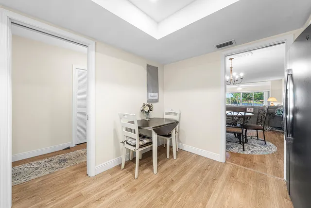 a dining room with furniture and wooden floor