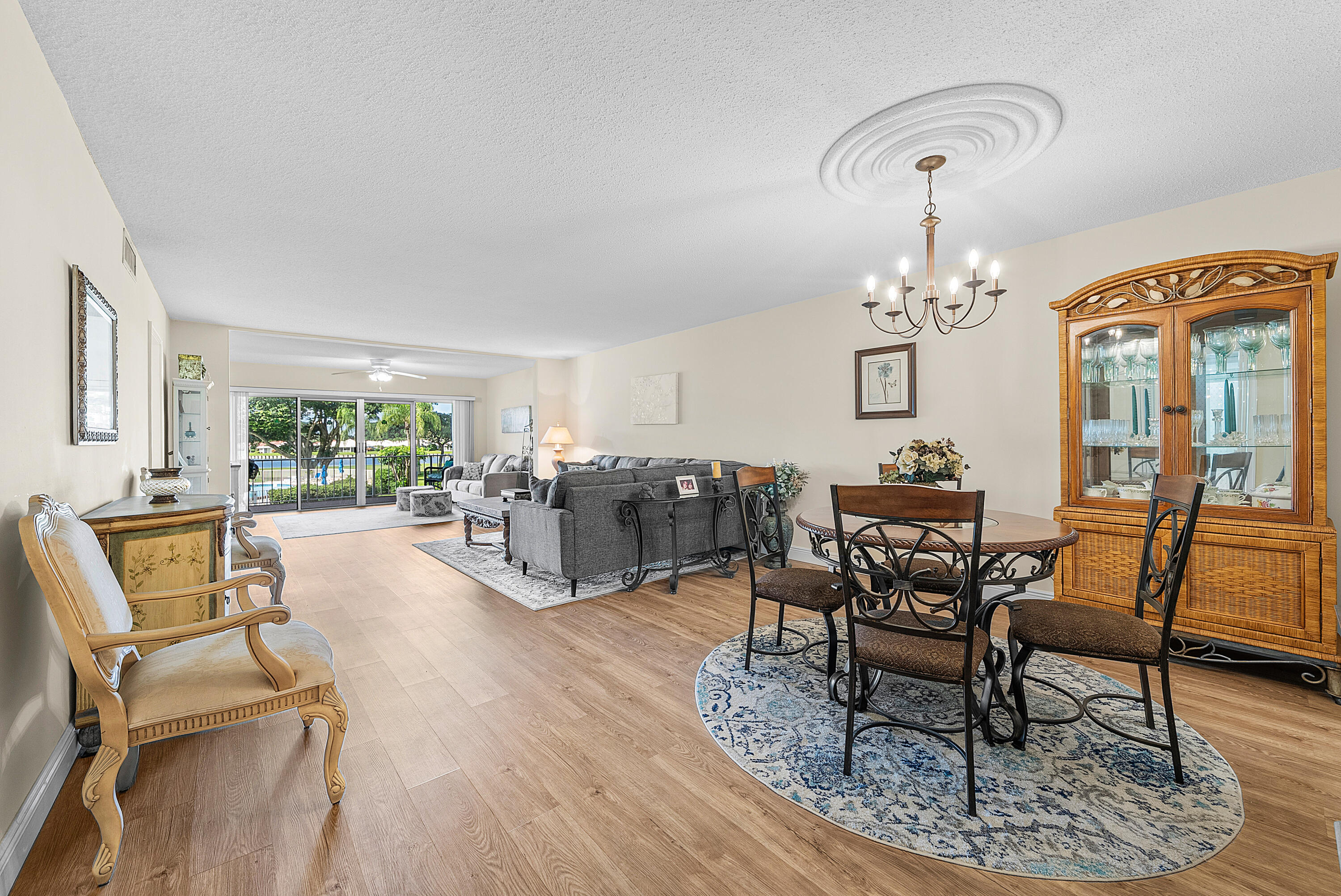 145 Atlantis Boulevard, Unit 203 Atlantis, FL 33462 - Photo 8 of 33 a living room with furniture and wooden floor