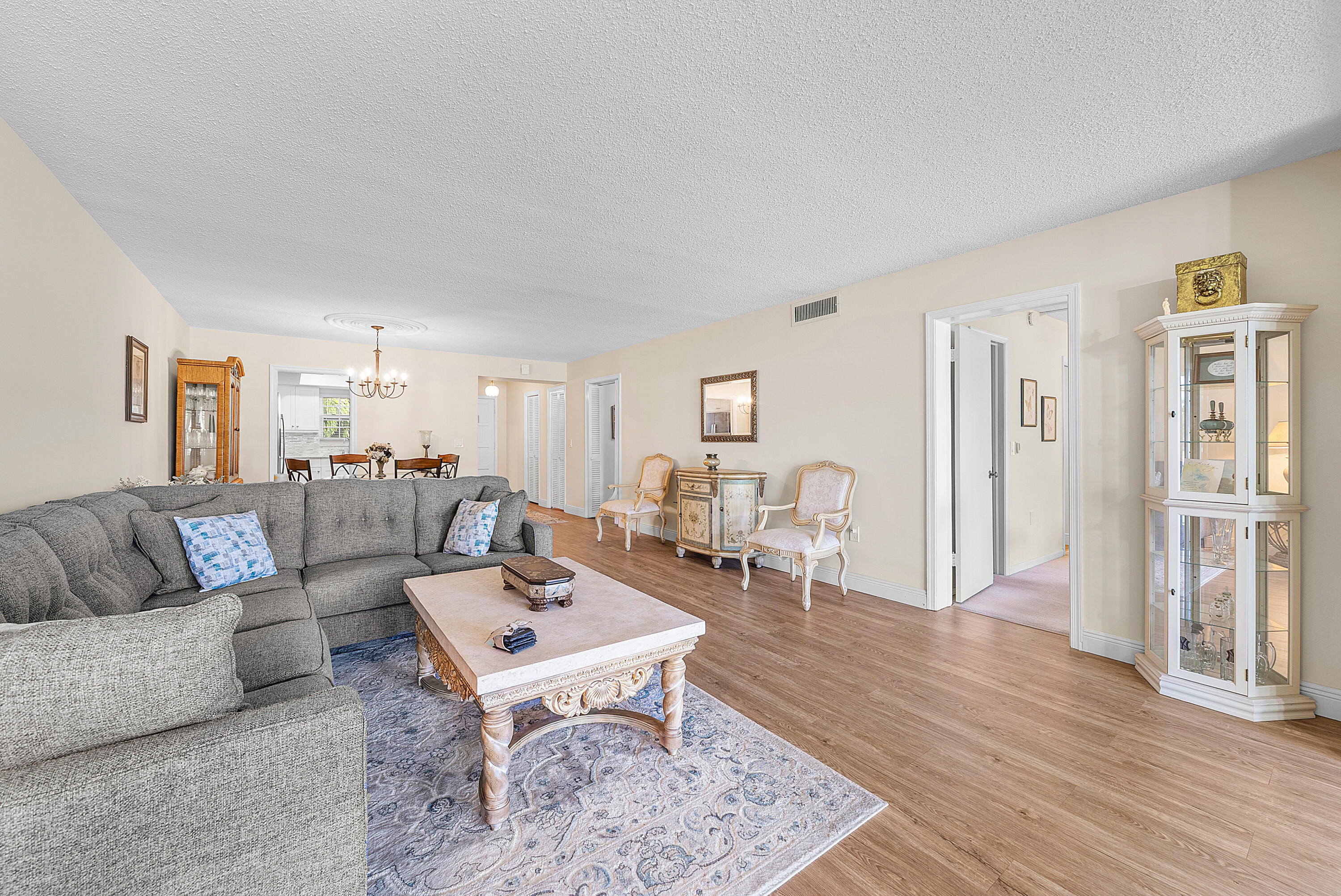 145 Atlantis Boulevard, Unit 203 Atlantis, FL 33462 - Photo 10 of 33 a living room with furniture and a wooden floor