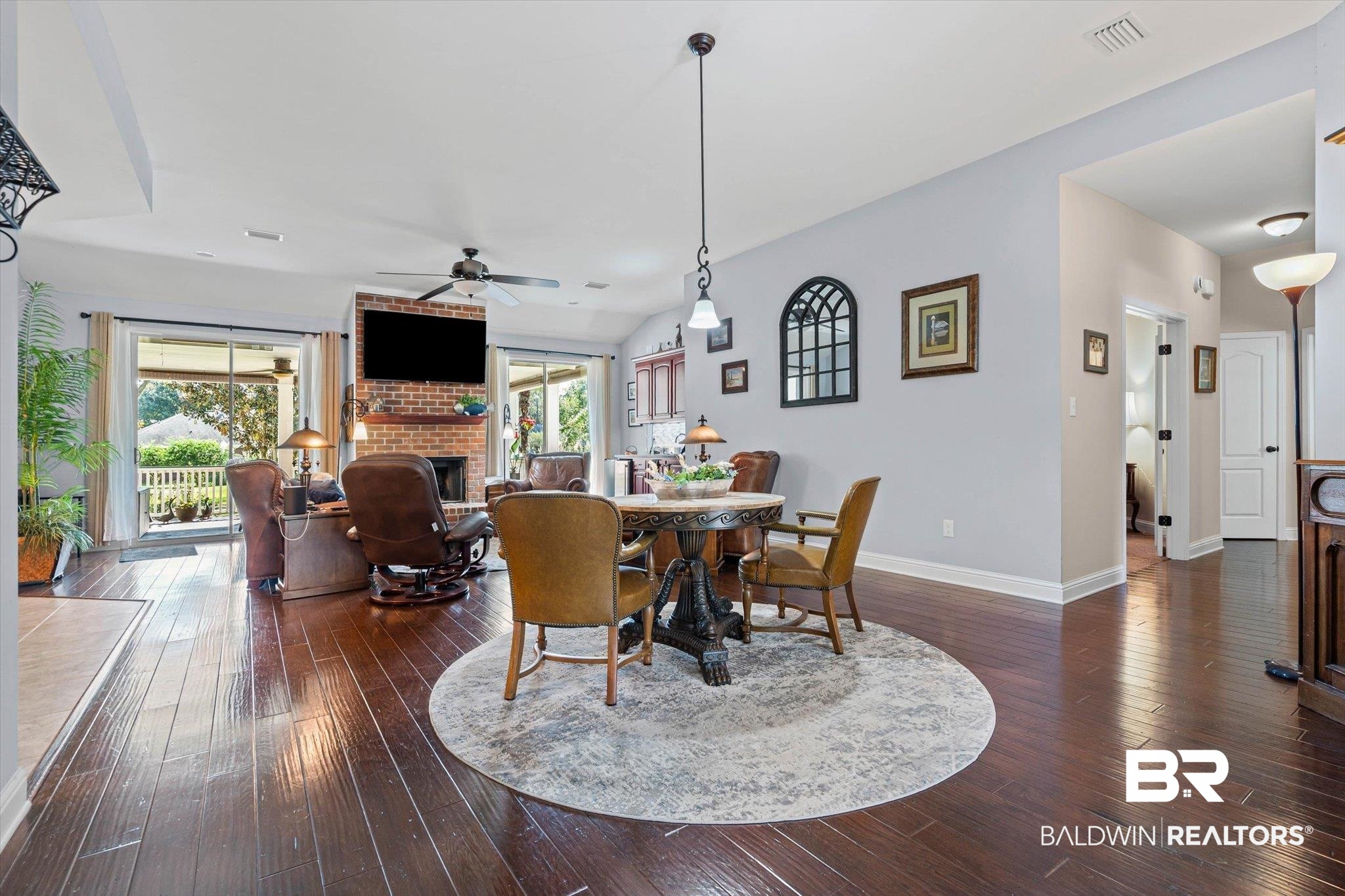 6175 South Grand Bay Wilmer Road Grand Bay, AL 36541 - Photo 3 of 42 Dining space with a fireplace, dark wood finished floors, and ceiling fan