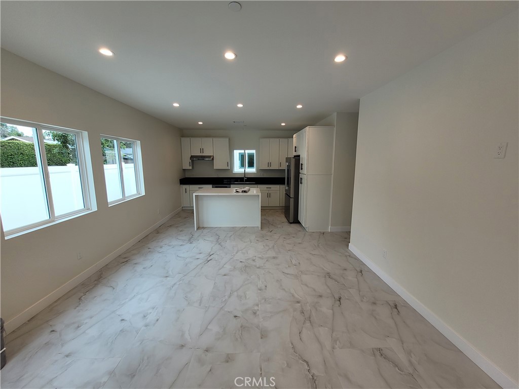 19453 Strathern Street Reseda, CA 91335 - Photo 4 of 12 a view of a kitchen with a sink and dishwasher a refrigerator with wooden floor