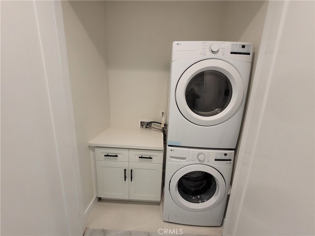19453 Strathern Street Reseda, CA 91335 - Photo 7 of 12 a utility room with dryer and washer